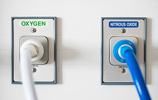 Oxygen output and nitrous oxide output outlets on a wall