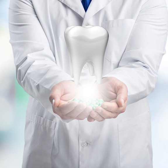 Dentist holding a large digital molar