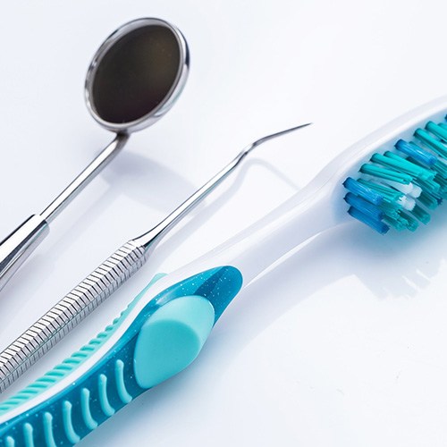 Toothbrush and dental instruments on white background